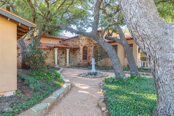 a view of a house with a tree front of house