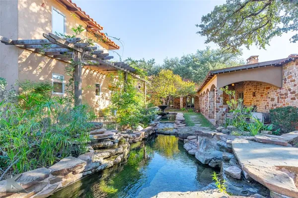 a swimming pool with outdoor seating and yard