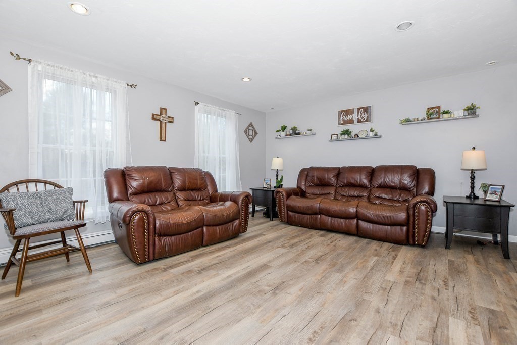 116 Tispaquin Street Middleboro, MA 02346 - Photo 11 of 37 a living room with a couch and a wooden floor
