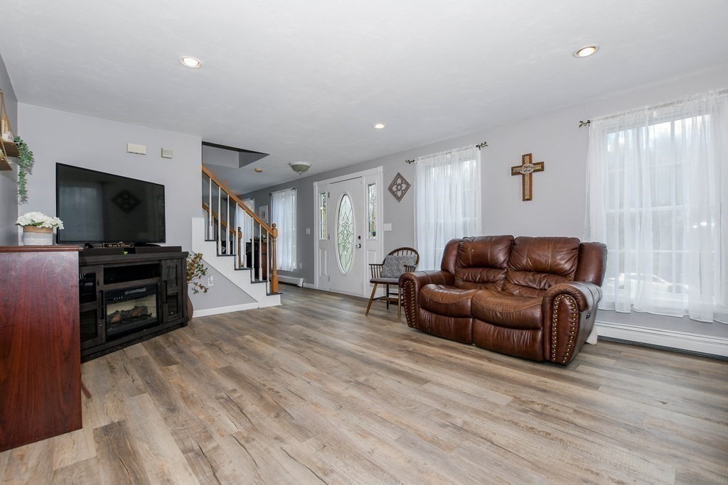116 Tispaquin Street Middleboro, MA 02346 - Photo 12 of 37 a living room with furniture and a flat screen tv