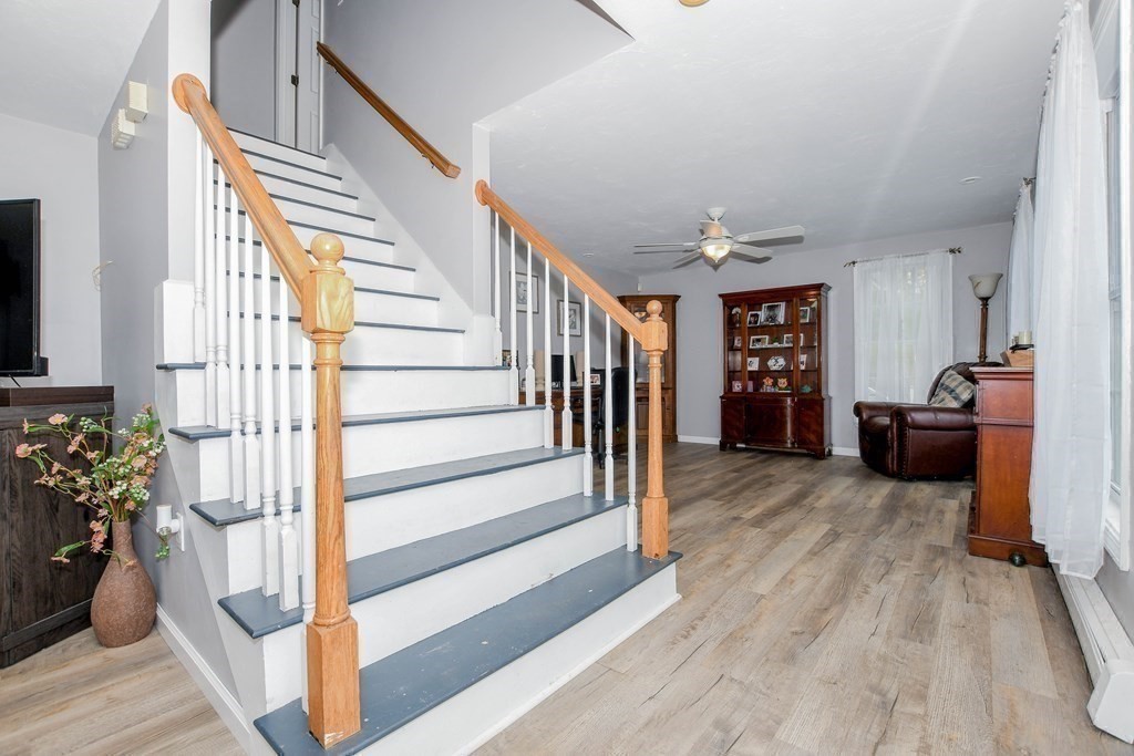 116 Tispaquin Street Middleboro, MA 02346 - Photo 13 of 37 a view of a livingroom with wooden floor and stairs