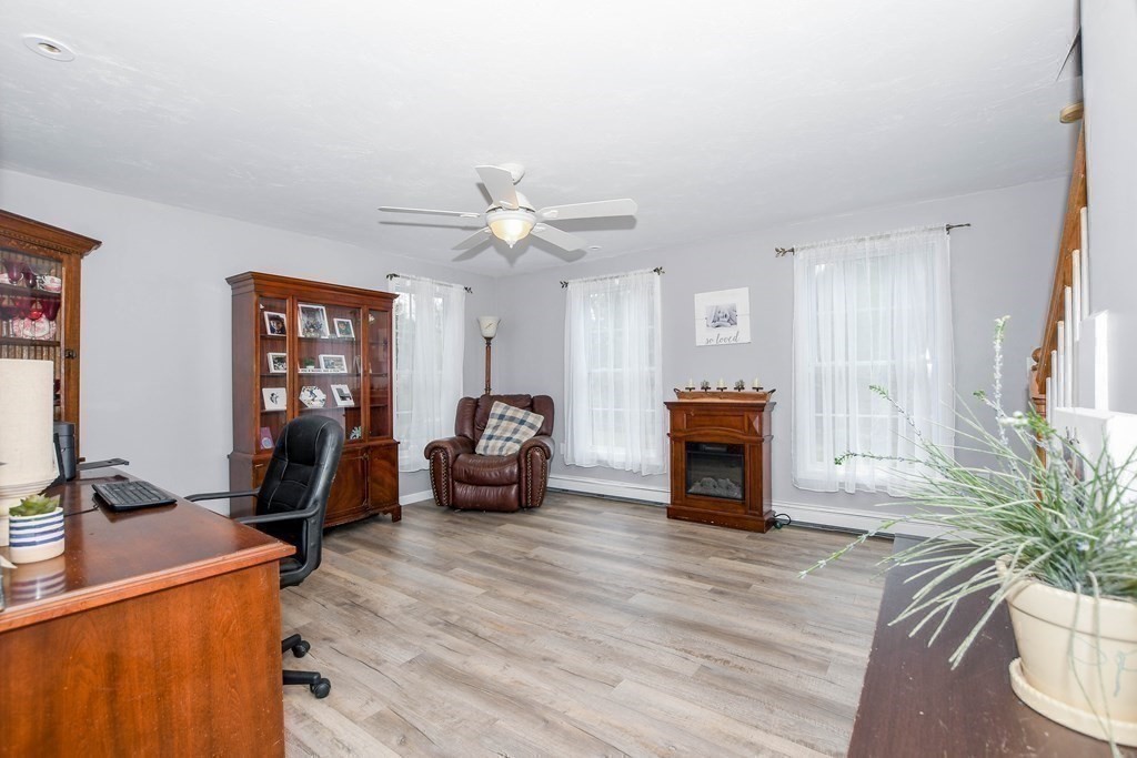 116 Tispaquin Street Middleboro, MA 02346 - Photo 15 of 37 a living room with furniture and a fireplace