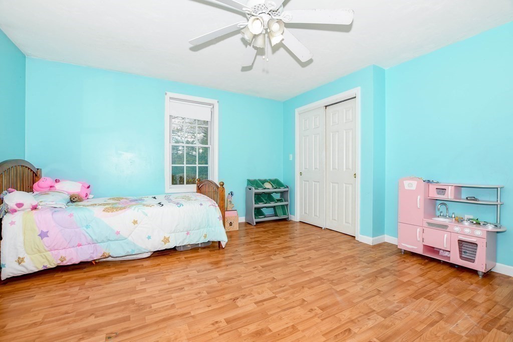 116 Tispaquin Street Middleboro, MA 02346 - Photo 17 of 37 a bedroom with a bed and a chandelier