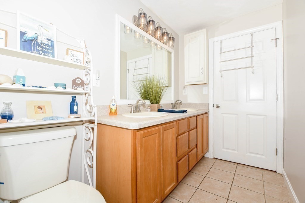 116 Tispaquin Street Middleboro, MA 02346 - Photo 20 of 37 a bathroom with a sink a toilet and a mirror