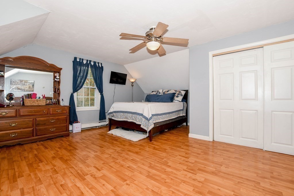 116 Tispaquin Street Middleboro, MA 02346 - Photo 27 of 37 a bedroom with a bed and a chandelier