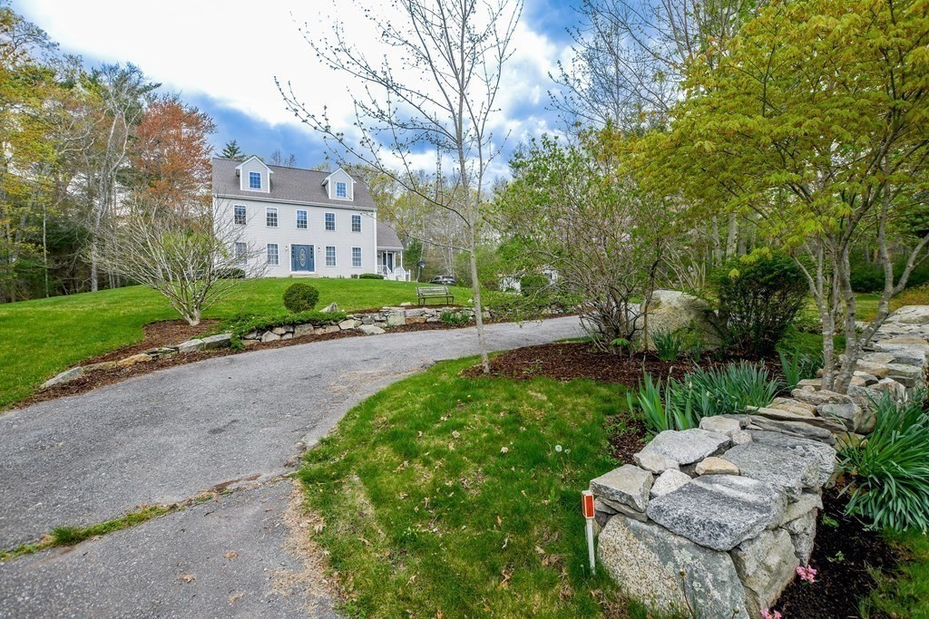 116 Tispaquin Street Middleboro, MA 02346 - Photo 3 of 37 a view of a yard with plants and a bench
