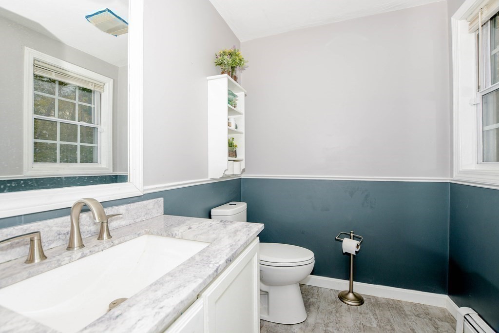 116 Tispaquin Street Middleboro, MA 02346 - Photo 32 of 37 a bathroom with a granite countertop sink a toilet and a window