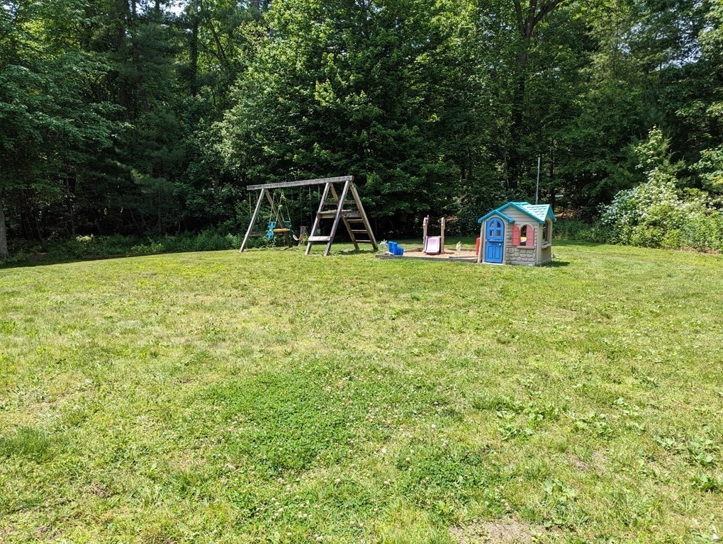 116 Tispaquin Street Middleboro, MA 02346 - Photo 35 of 37 a backyard of a house with trampoline and plants