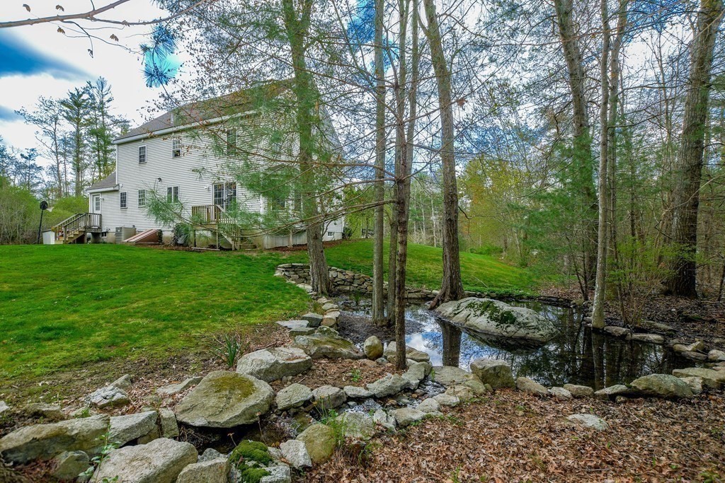 116 Tispaquin Street Middleboro, MA 02346 - Photo 36 of 37 a backyard of a house with lots of green space