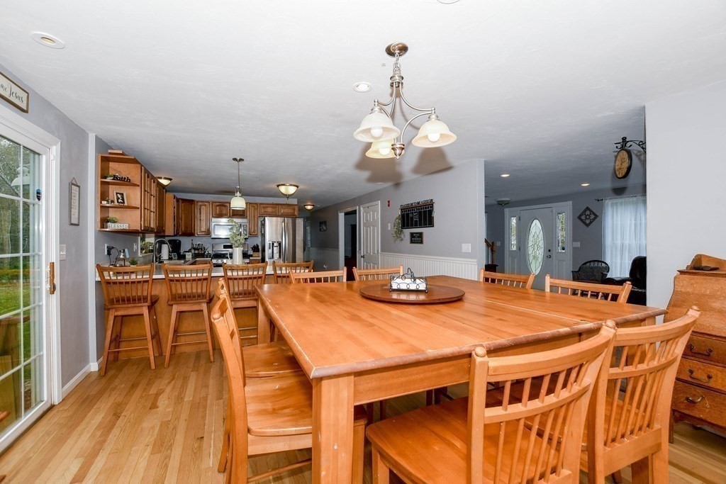 116 Tispaquin Street Middleboro, MA 02346 - Photo 5 of 37 a dining room with stainless steel appliances kitchen island granite countertop a dining table chairs and chandelier