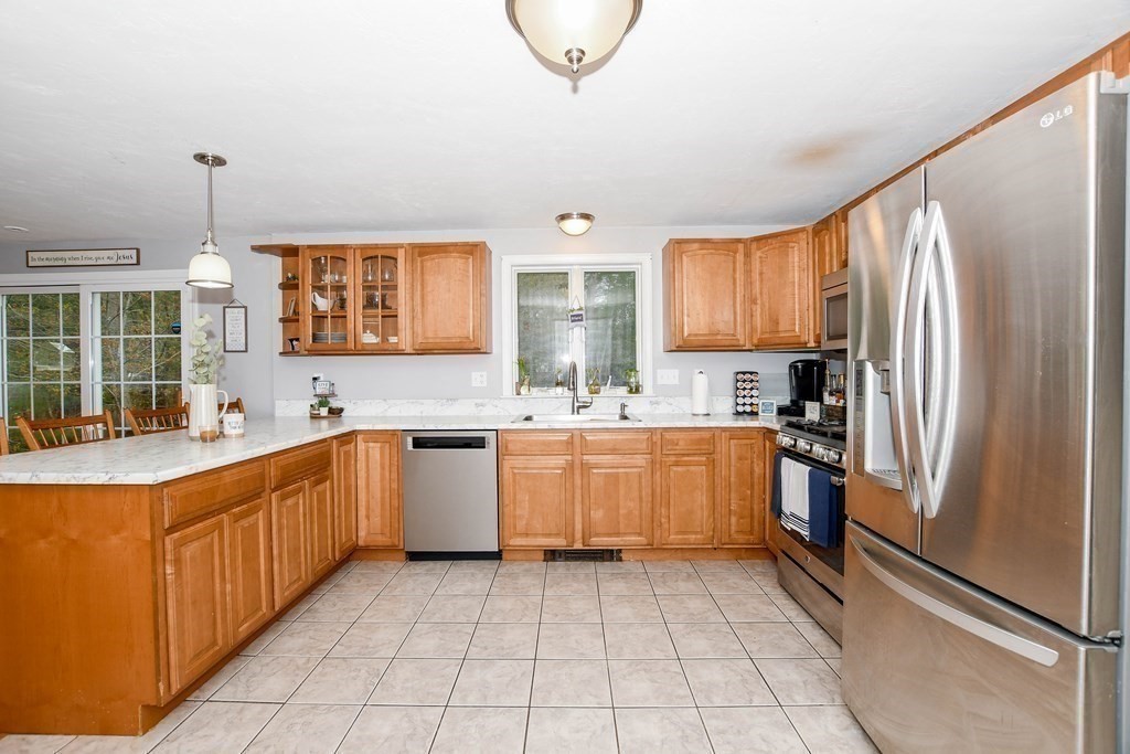 116 Tispaquin Street Middleboro, MA 02346 - Photo 8 of 37 a kitchen with a refrigerator sink and cabinets