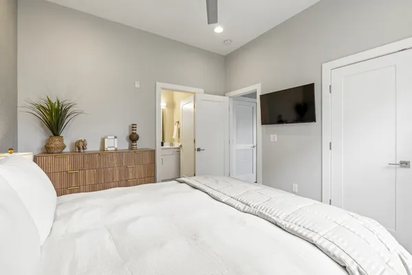a bedroom with a bed and a flat screen tv