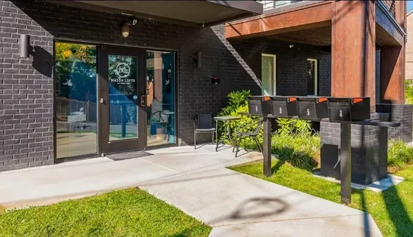 a view of two chairs and table in a patio