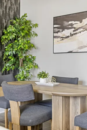 a living room with a table and a potted plant