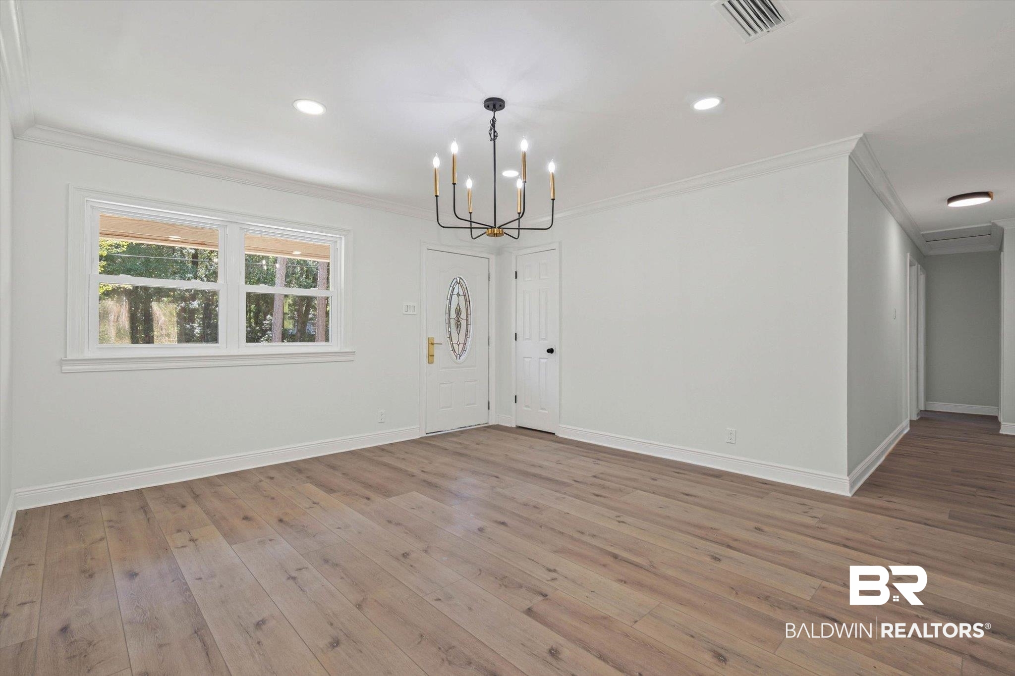 4156 Furman Drive Mobile, AL 36619 - Photo 5 of 24 Unfurnished dining area featuring ornamental molding, light wood finished floors, a chandelier, and recessed lighting