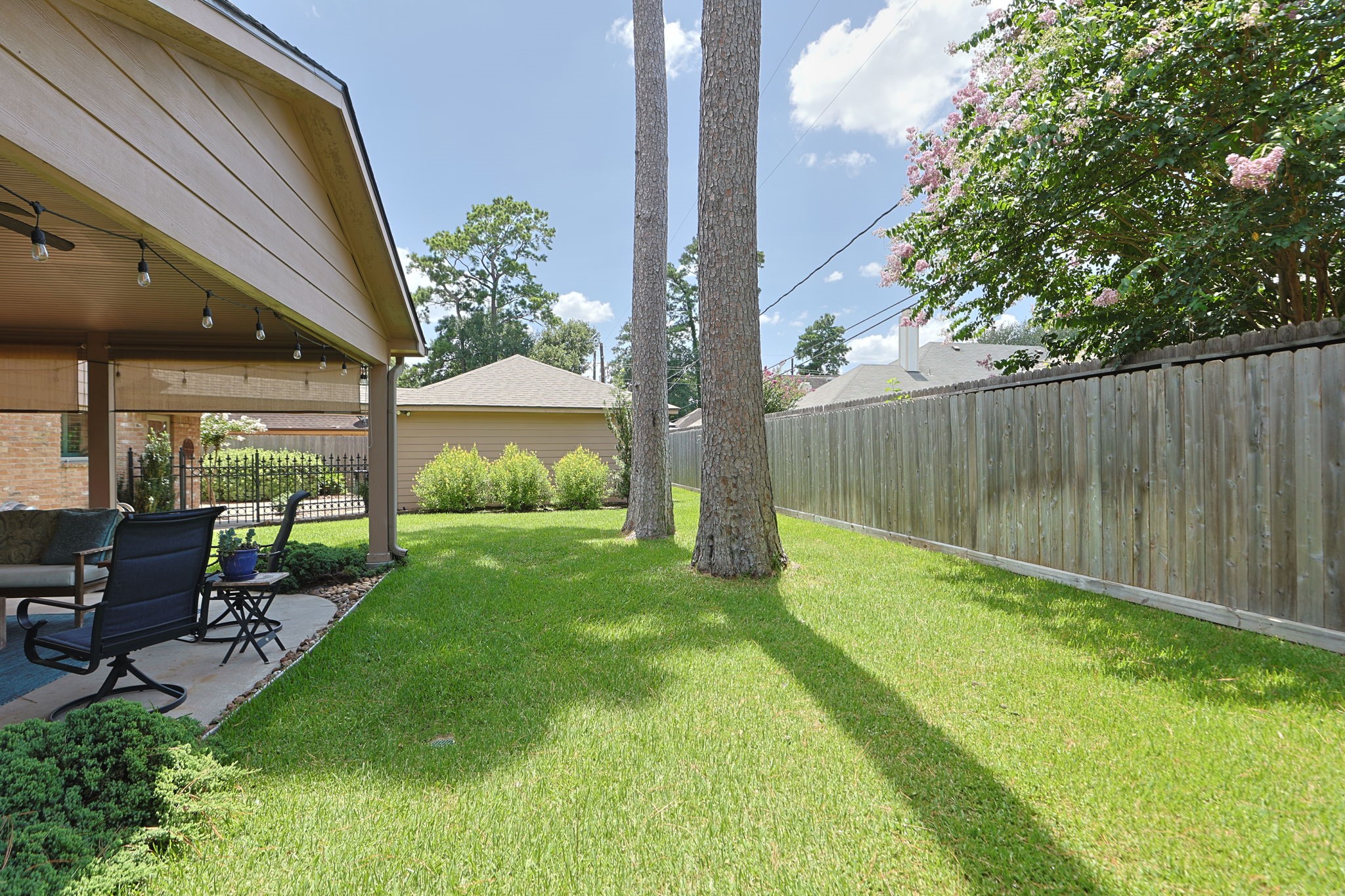 3414 Flaming Candle Drive Spring, TX 77388 - Photo 44 of 50 BACK YARD - The pretty landscaping surrounds the patio area and extends to the side of the garage as well. Every spot in this yard is well-manicured.