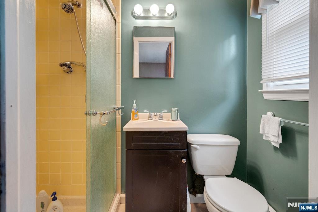 185 Ratzer Road Wayne, NJ 07470 - Photo 31 of 36 a white toilet sitting next to a bathroom sink