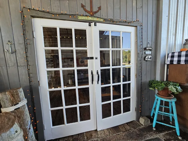 a view of a house with a yard and a large tree