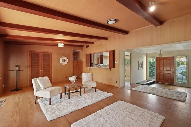 a living room with furniture and wooden floor