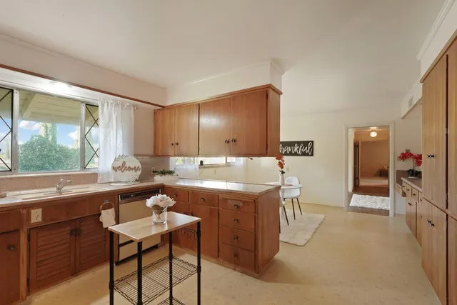 a large kitchen with a table and chairs in it