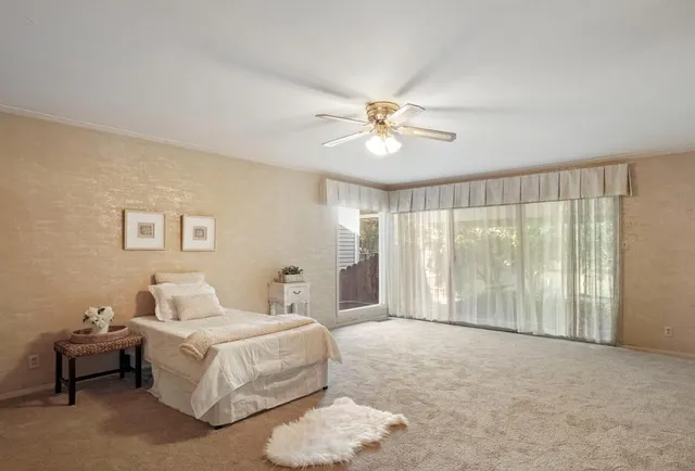 a spacious bedroom with a bed and a chandelier
