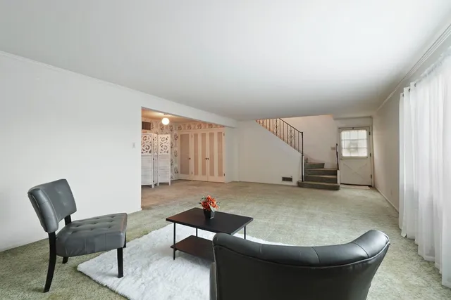 a utility room with a washer dryer and white cabinets
