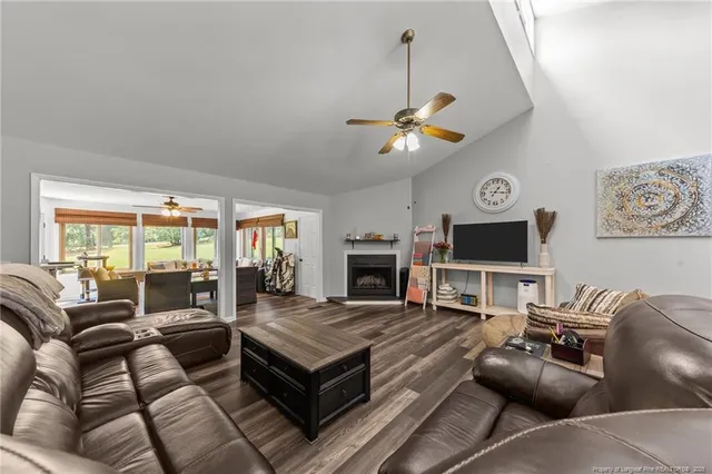 a living room with furniture a fireplace and a flat screen tv
