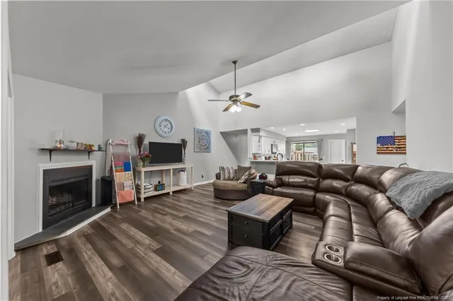 a living room with furniture fireplace and flat screen tv