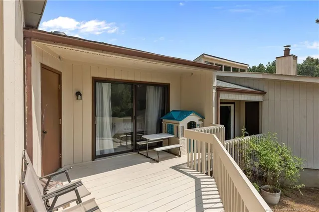 a view of a balcony with chair and front door