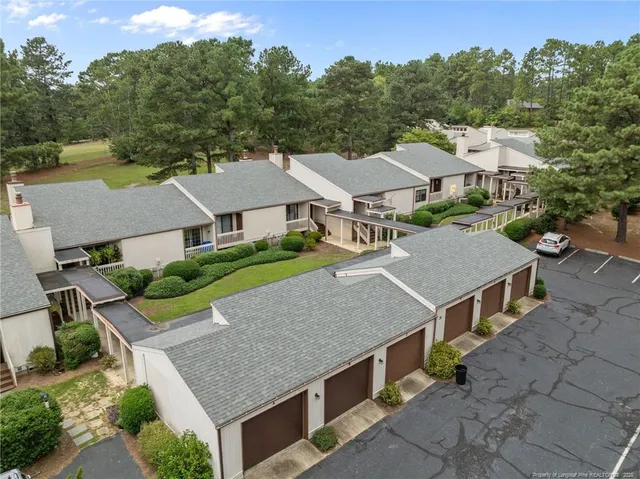 an aerial view of a house with yard porch and furniture