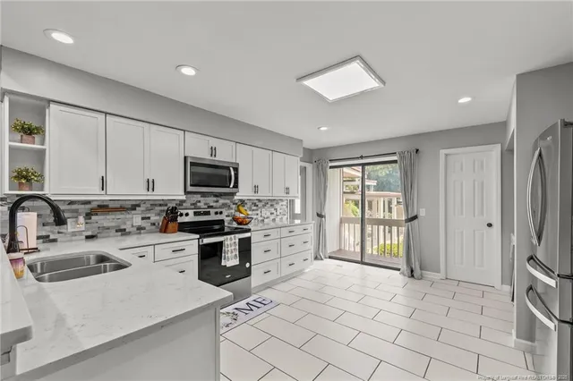 a kitchen with a sink a stove and refrigerator