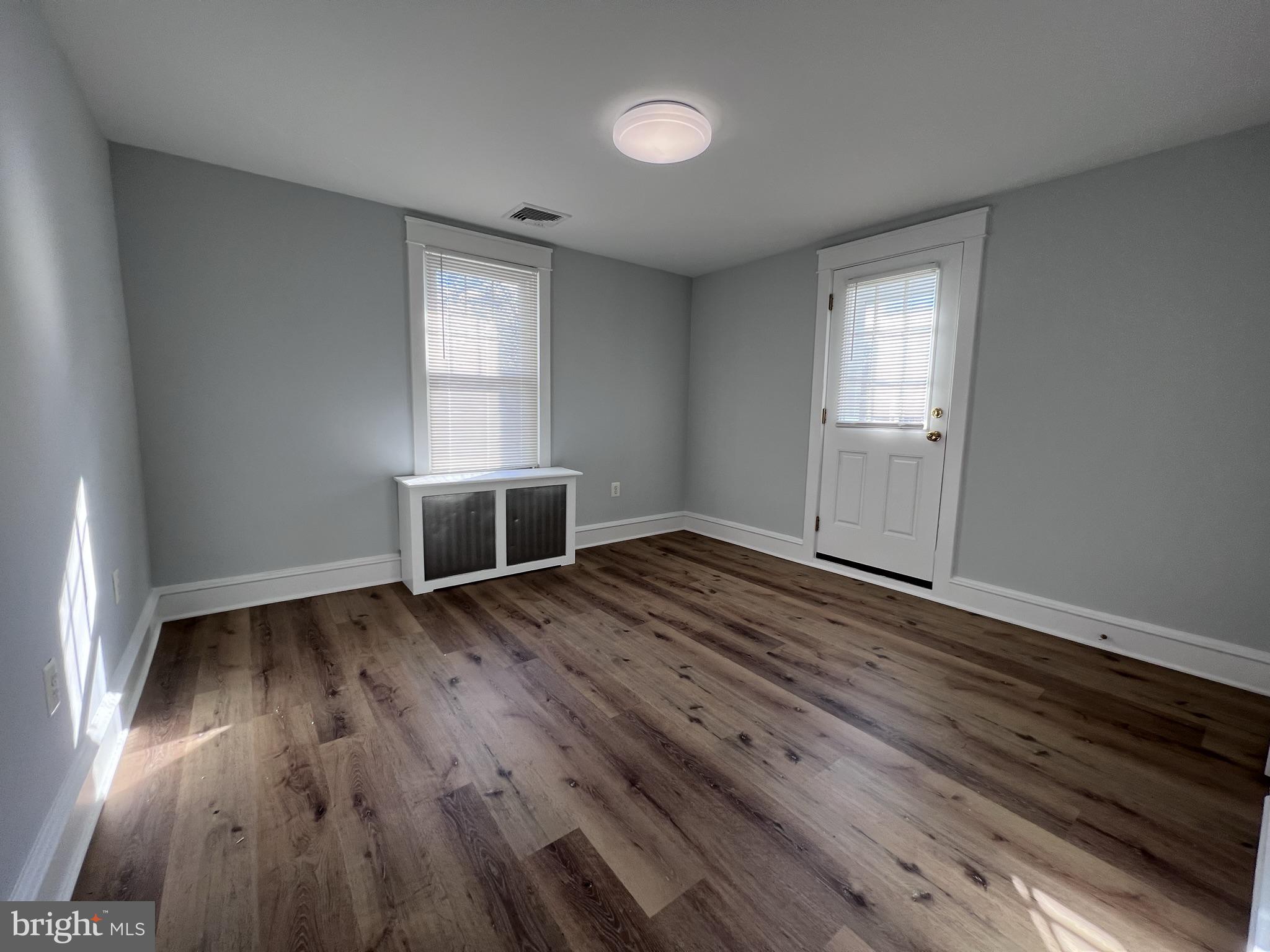 6 Montgomery Avenue, Unit 2 Glenside, PA 19038 - Photo 4 of 27 wooden floor in an empty room with a window