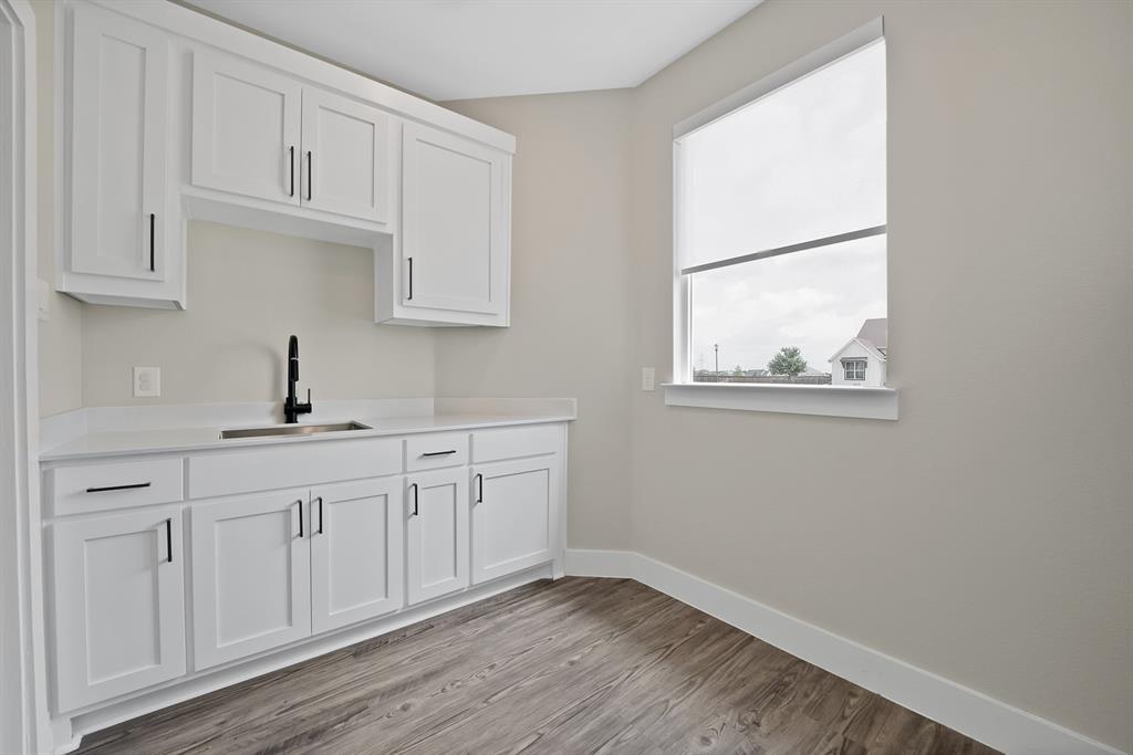 2223 Providence Way Nevada, TX 75173 - Photo 27 of 40 a kitchen with white cabinets and sink
