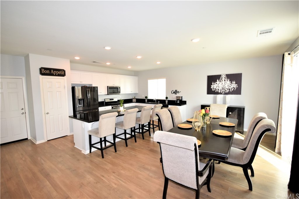 581 Poo'ish Avenue San Jacinto, CA 92582 - Photo 13 of 32 a dining room with furniture and wooden floor