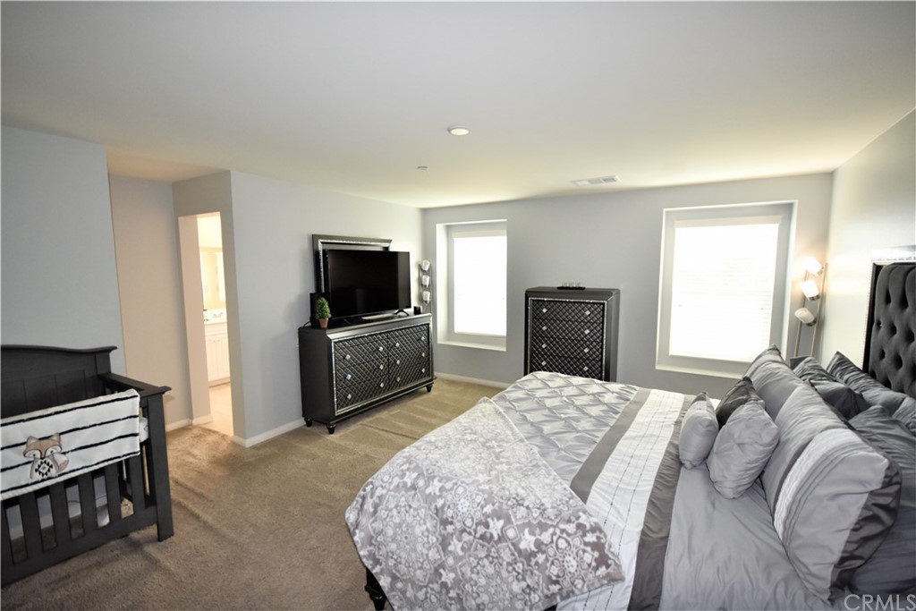 581 Poo'ish Avenue San Jacinto, CA 92582 - Photo 17 of 32 a bedroom with a bed and a television