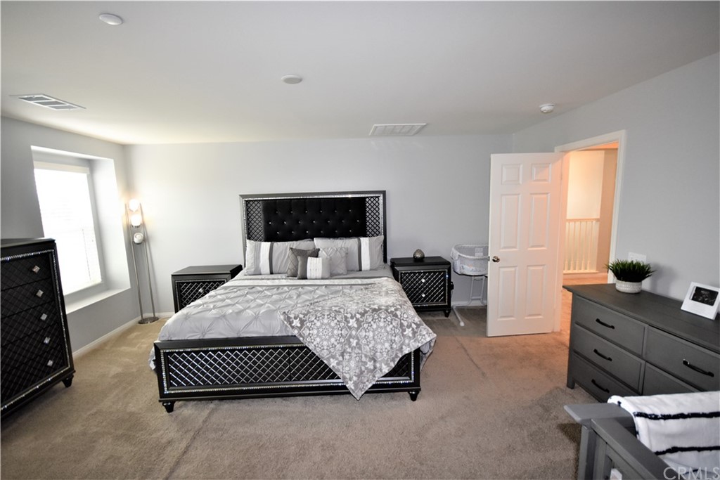 581 Poo'ish Avenue San Jacinto, CA 92582 - Photo 18 of 32 a bedroom with a bed and window