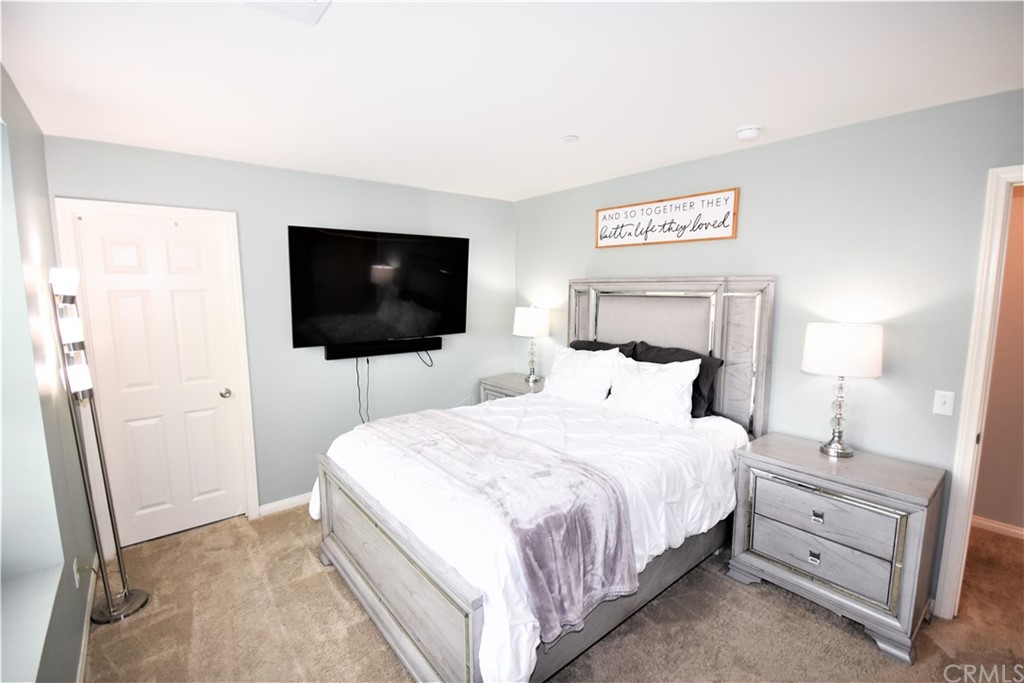581 Poo'ish Avenue San Jacinto, CA 92582 - Photo 25 of 32 a bedroom with a bed and a flat screen tv