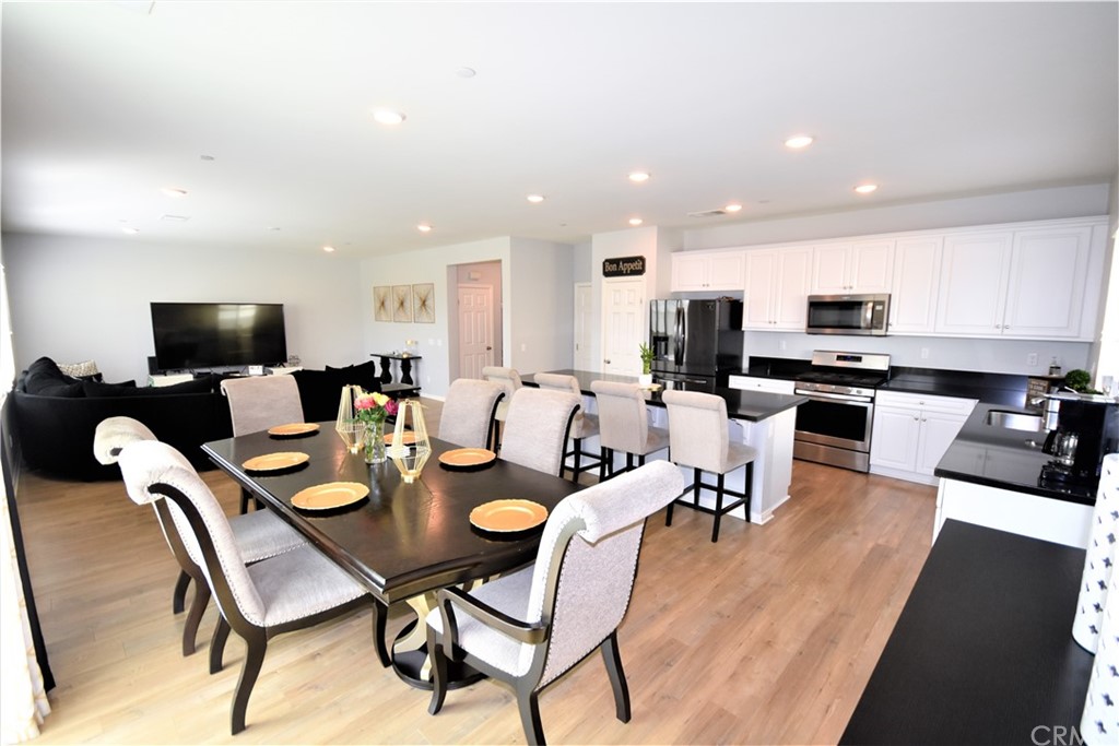 581 Poo'ish Avenue San Jacinto, CA 92582 - Photo 7 of 32 a dining room with lots of furniture and a flat screen tv