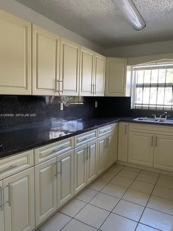 a view of a utility room with cabinets