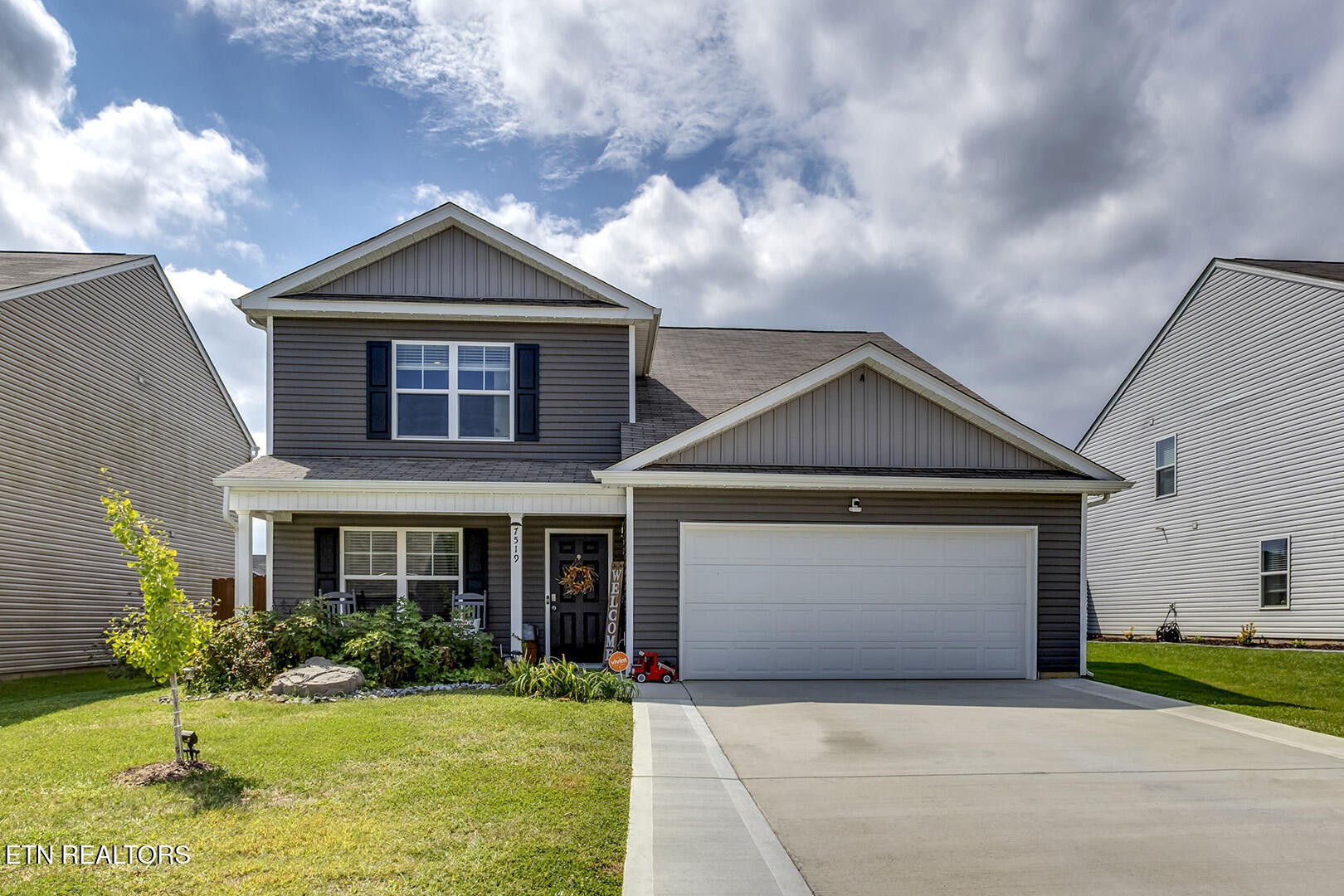 a front view of a house with a yard and garage