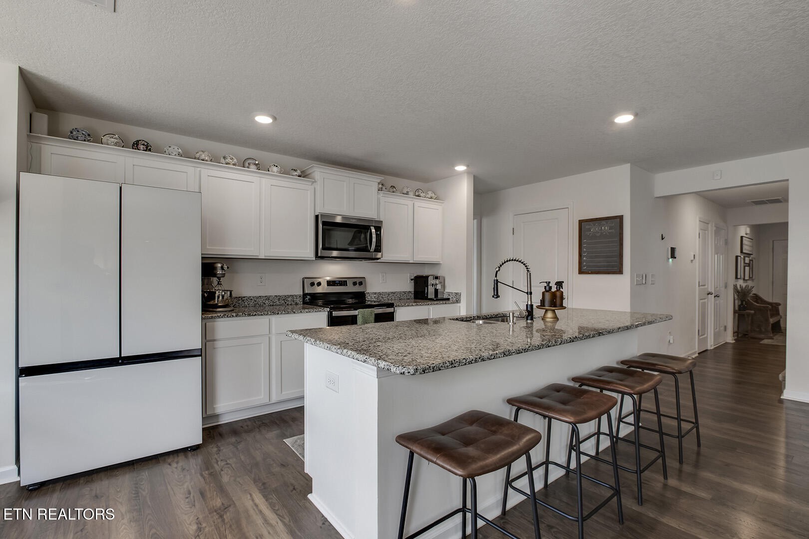 7519 Game Bird Street Corryton, TN 37721 - Photo 12 of 50 a kitchen with granite countertop a sink appliances a counter space and cabinets
