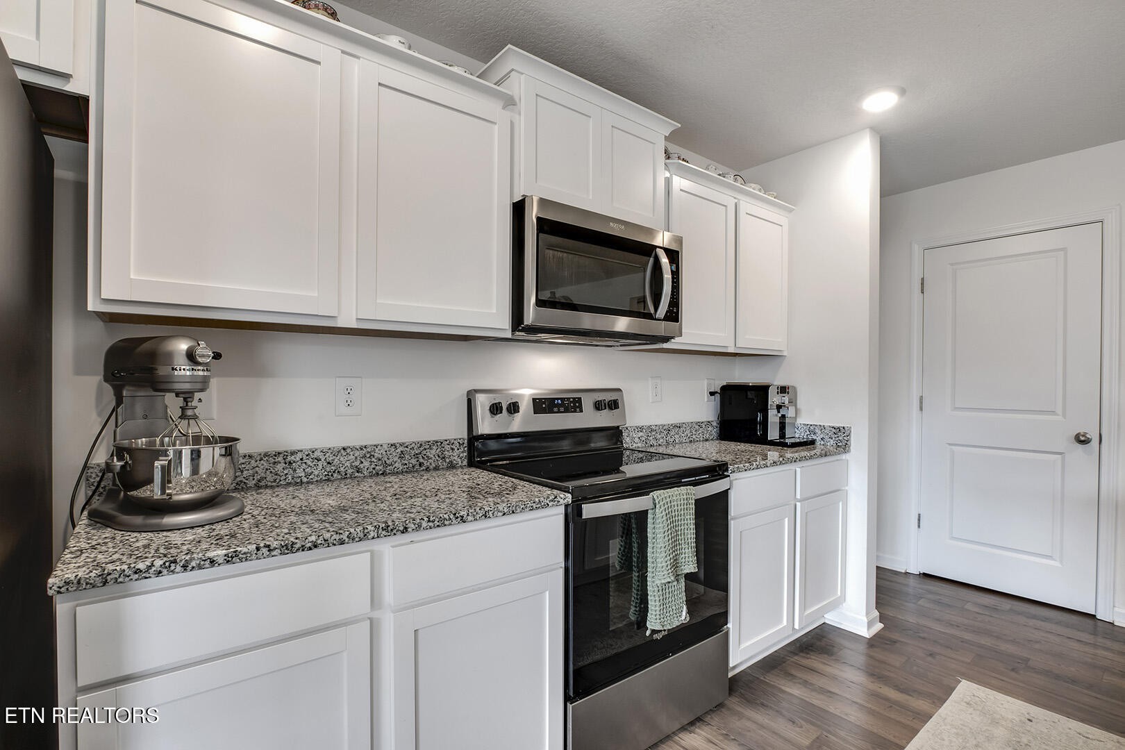 7519 Game Bird Street Corryton, TN 37721 - Photo 14 of 50 a kitchen with granite countertop white cabinets stainless steel appliances and a sink