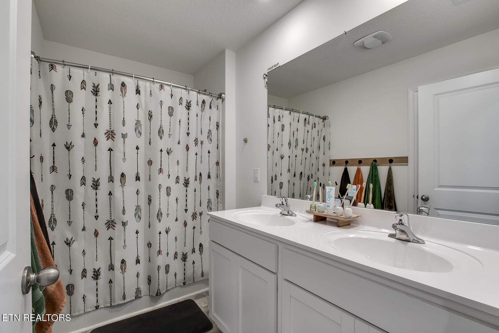 7519 Game Bird Street Corryton, TN 37721 - Photo 38 of 50 a bathroom with double vanity sink a mirror and shower curtain