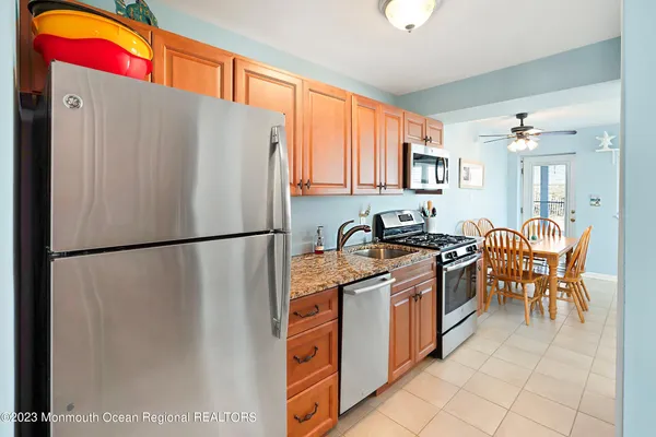 a kitchen with stainless steel appliances granite countertop a stove and a microwave