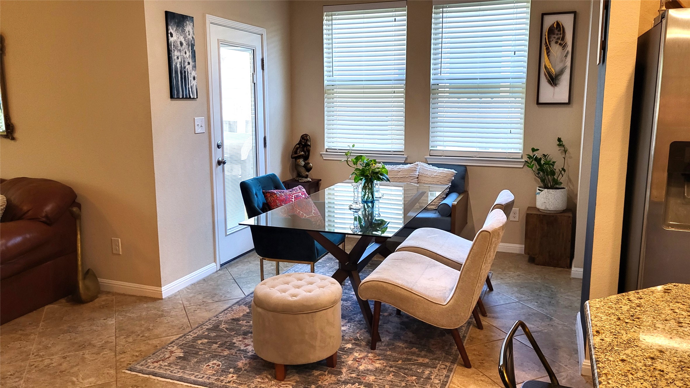 413 Anacua Loop, Unit 8 Manchaca, TX 78652 - Photo 12 of 23 Natural light flows across tiled floors in this inviting casual dining area.