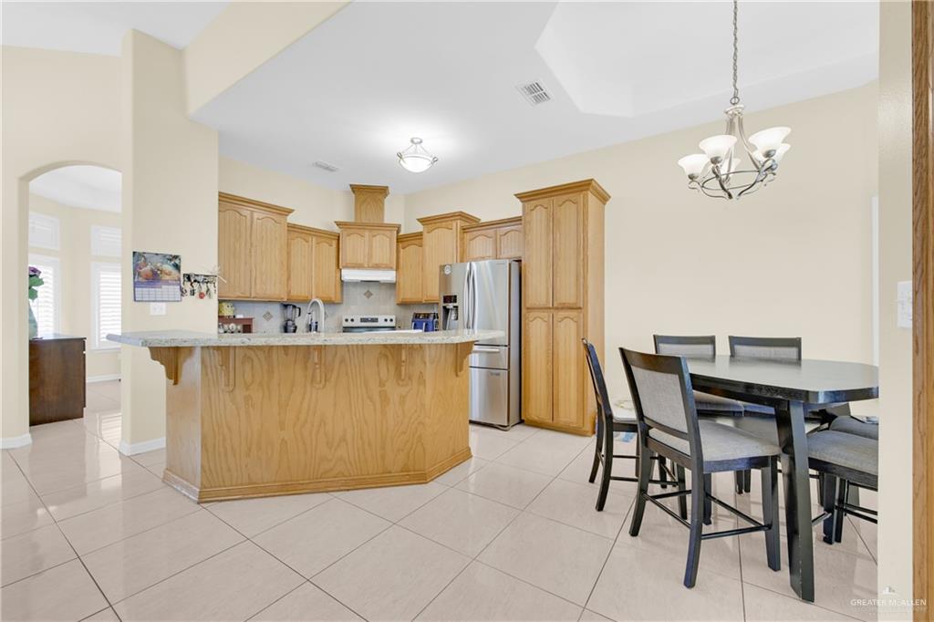 305 North 15th Street Hidalgo, TX 78557 - Photo 12 of 28 a view of a dining room with furniture and chandelier