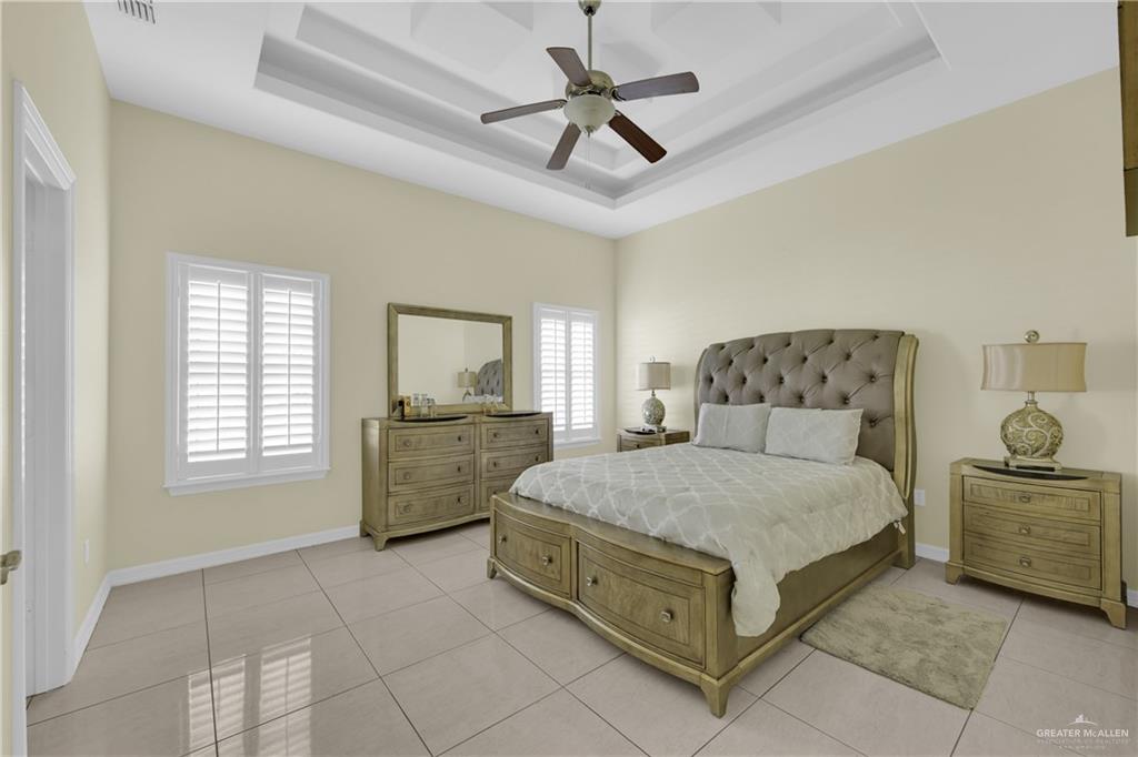305 North 15th Street Hidalgo, TX 78557 - Photo 15 of 28 a bedroom with a bed and a chandelier fan