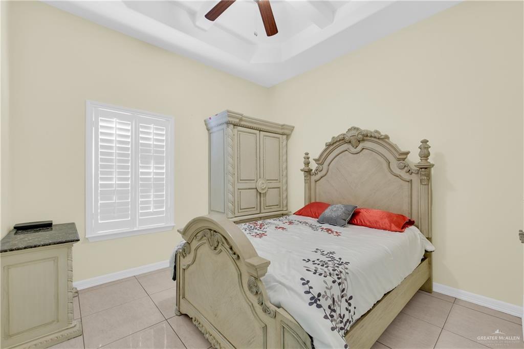 305 North 15th Street Hidalgo, TX 78557 - Photo 17 of 28 a bedroom with a bed and dresser with mirror