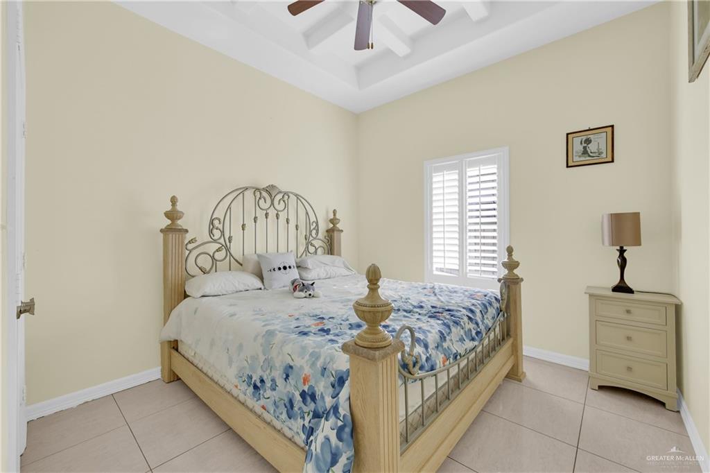 305 North 15th Street Hidalgo, TX 78557 - Photo 18 of 28 a bedroom with a bed a chandelier and a window