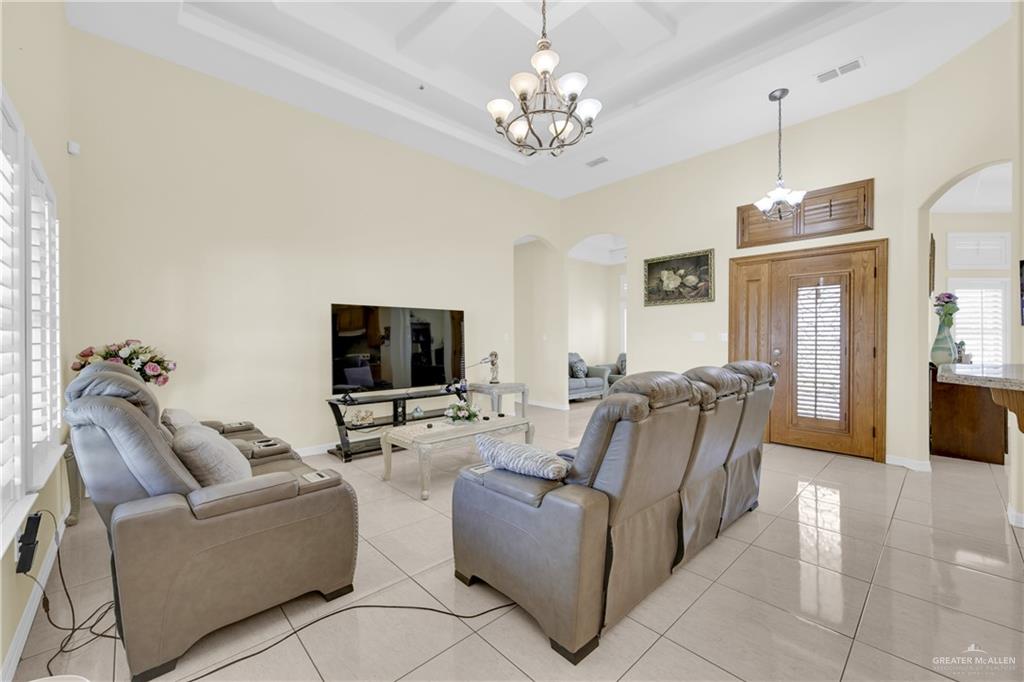 305 North 15th Street Hidalgo, TX 78557 - Photo 7 of 28 a living room with furniture a flat screen tv and a chandelier